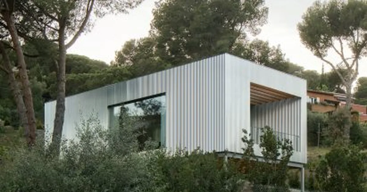 Metal-clad home perched on steel supports above Barcelona coast